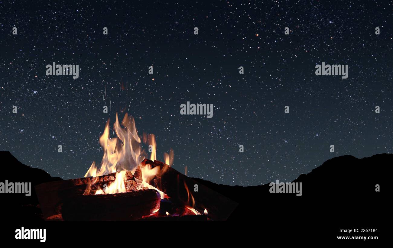 a bonfire burns at night against the background of mountains and sea with bright stars.. Stock Photo