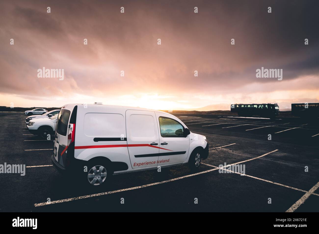 Reykjavik, Iceland - march 15th, 2023: white camper van stand in parking lot in Iceland with sunset background Stock Photo