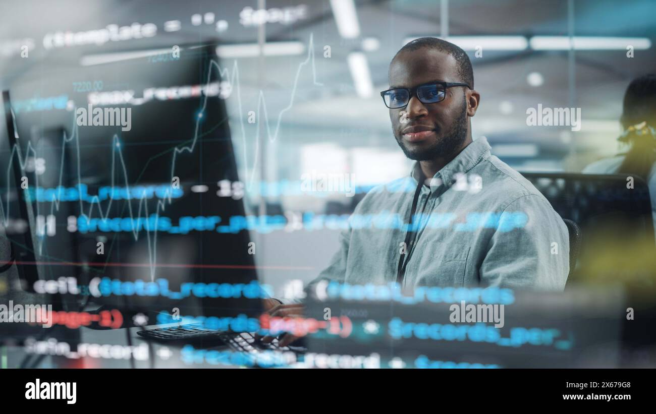Real Office: Professional Black IT Programmer Working on Desktop Computer. Male Website Developer and Software Engineer Developing App, Video Game. Shot with Visual Effects of Running Code. Stock Photo
