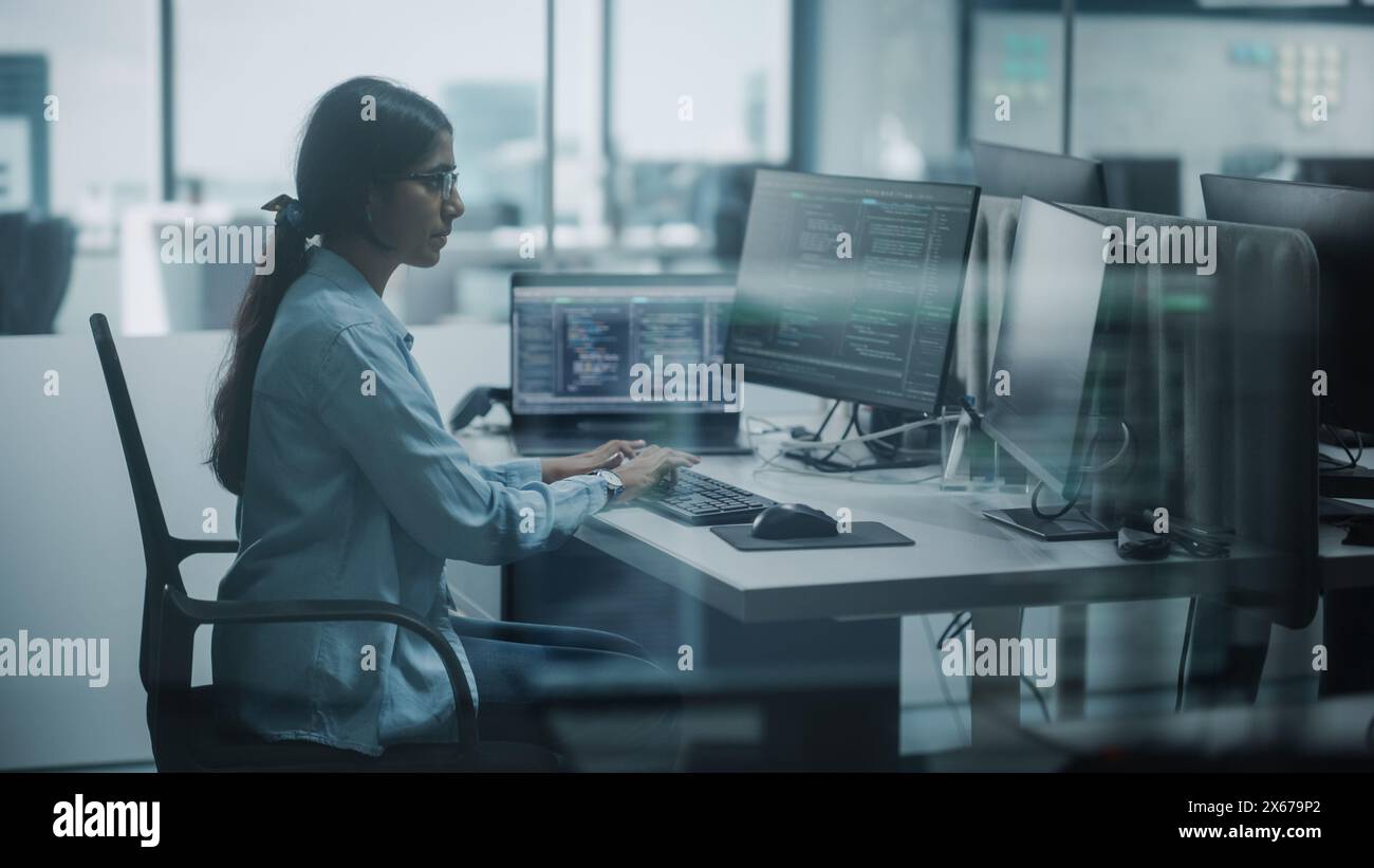 Diverse Office: Indian IT Programmer Working on Desktop Computer. Female Specialist Creating Innovative Software. Engineer Developing App, Program, Video Game. Writing Code. Stock Photo