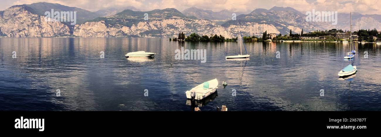 Alpine Panorama on Lake Garda in Italy with Few Moored Boats Before the Start of the Holiday Season Stock Photo