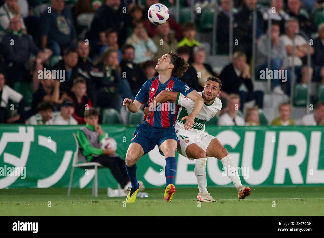 Elche, Spain. 13th May, 2024. ELCHE, SPAIN - MAY 12: Jose Salinas Left-Back of Elche CF competes for the ball with Javi Martinez Attacking Midfield of SD Huesca during the LaLiga Hypermotion match between Elche CF and SD Huesca at Manuel Martinez Valero Stadium, on May 12, 2024 in Elche, Alicante, Spain. (Photo By Francisco Macia/Photo Players Images) Credit: Magara Press SL/Alamy Live News Stock Photo