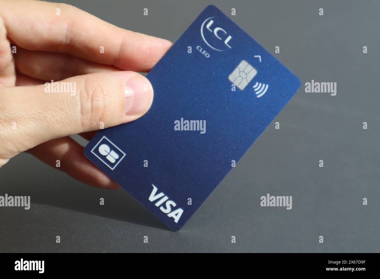 Nice, France - 11.05.2024: Man's hand holding a Visa bank card LCL (Credit Lyonnais) Stock Photo