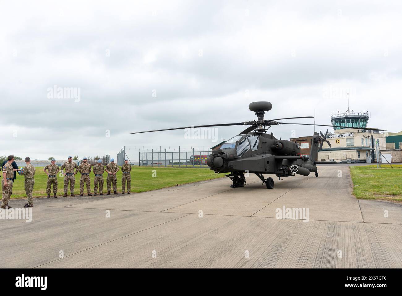 Middle Wallop, UK, 13 May, 2024. Military service men and women stand next to an Apache helicopter as His Majesty King Charles III  officially handed over the role of Colonel-in-Chief of the Army Air Corps to His Royal Highness The Prince of Wales at the Army Aviation Centre in Middle Wallop, Hampshire. Credit: A.A. Gill/Alamy Live News Stock Photo