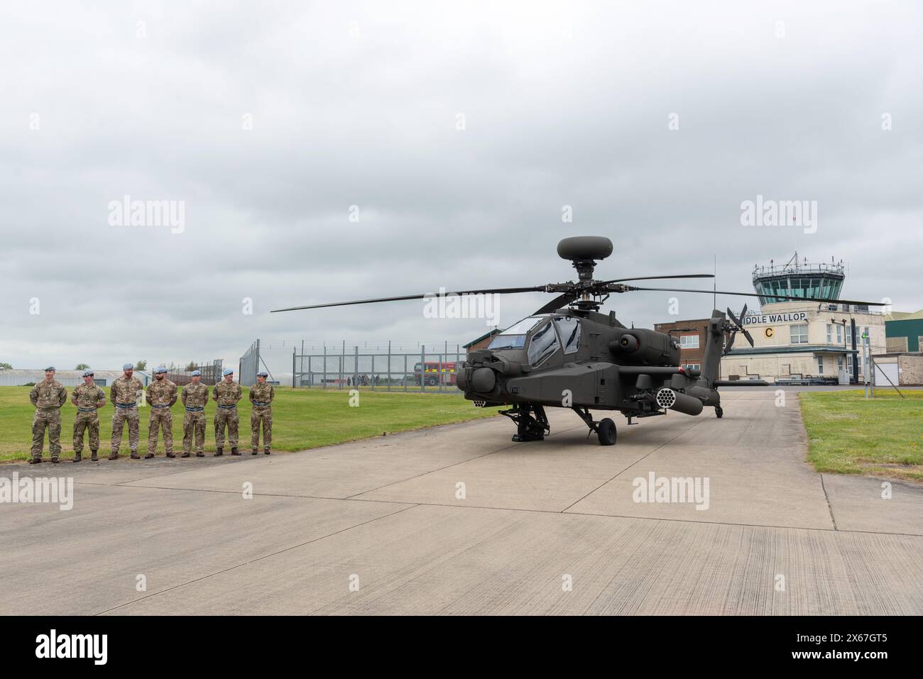 Middle Wallop, UK, 13 May, 2024. Military service men and women stand next to an Apache helicopter as His Majesty King Charles III  officially handed over the role of Colonel-in-Chief of the Army Air Corps to His Royal Highness The Prince of Wales at the Army Aviation Centre in Middle Wallop, Hampshire. Credit: A.A. Gill/Alamy Live News Stock Photo