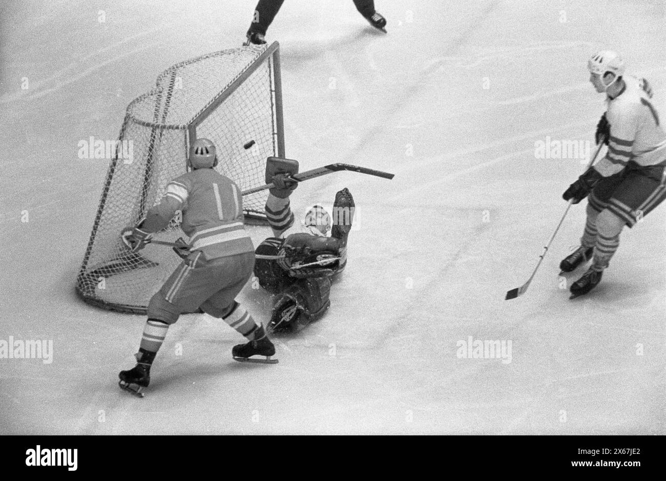 Vintage Winter Olympics Games Photo: Grenoble 68, Ice hockey competition.   USSR v Sweden 3-2, Anatoly Firsov (USSR) scores, Swedish goalie unable to make the save, February 13, 1968, Stock Photo