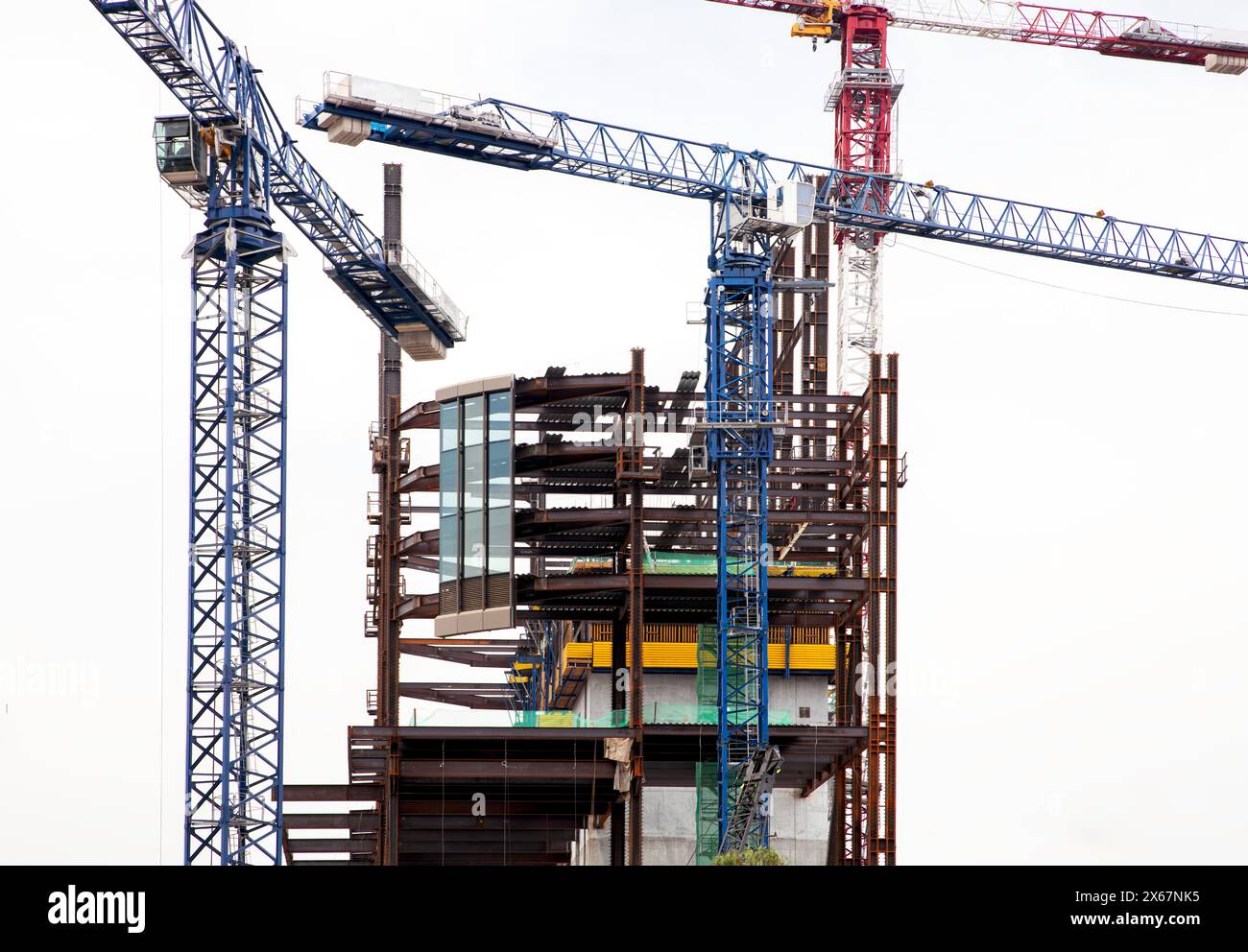 Construction cranes at building site Stock Photo