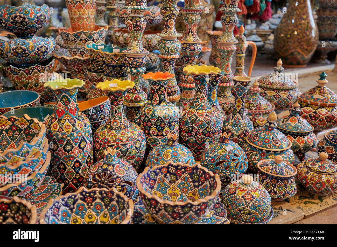 Colorful selection of traditional handmade pottery and ceramics displayed in a gift shop in the Vakil Bazaar. Shiraz, Iran. Stock Photo