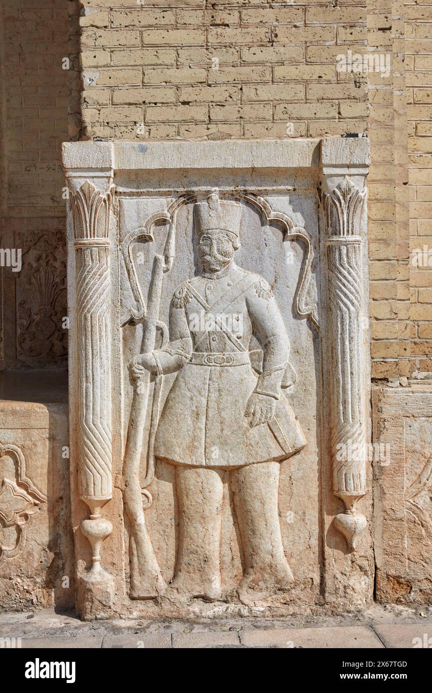 Relief depicting a 19th century Persian soldier with rifle in Qavam House (Narenjestan-e Ghavam), historical house of Qajar era. Shiraz, Iran. Stock Photo