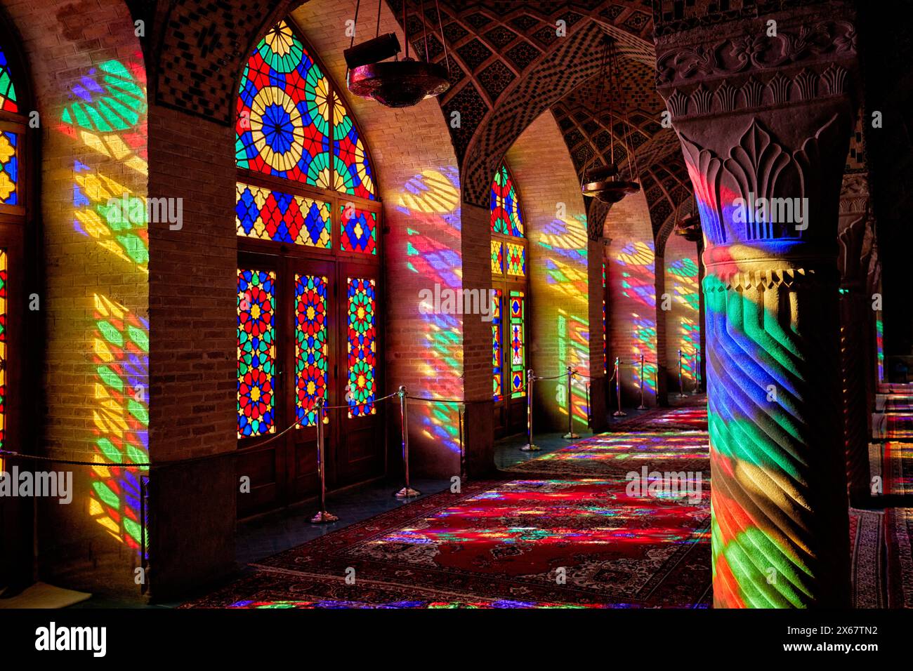 A play of light from multi-colored stained-glass windows inside the ...