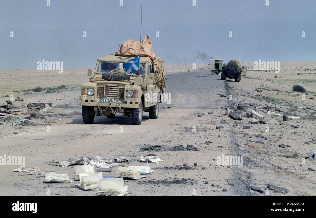 5th March 1991 A British Army Land Rover of the King's Own Scottish Borderers passes Iraqi military vehicles abandoned and wrecked, recently attacked by USAF fighter jets on Route 801, the road to Um Qasr, north of Kuwait City. Stock Photo
