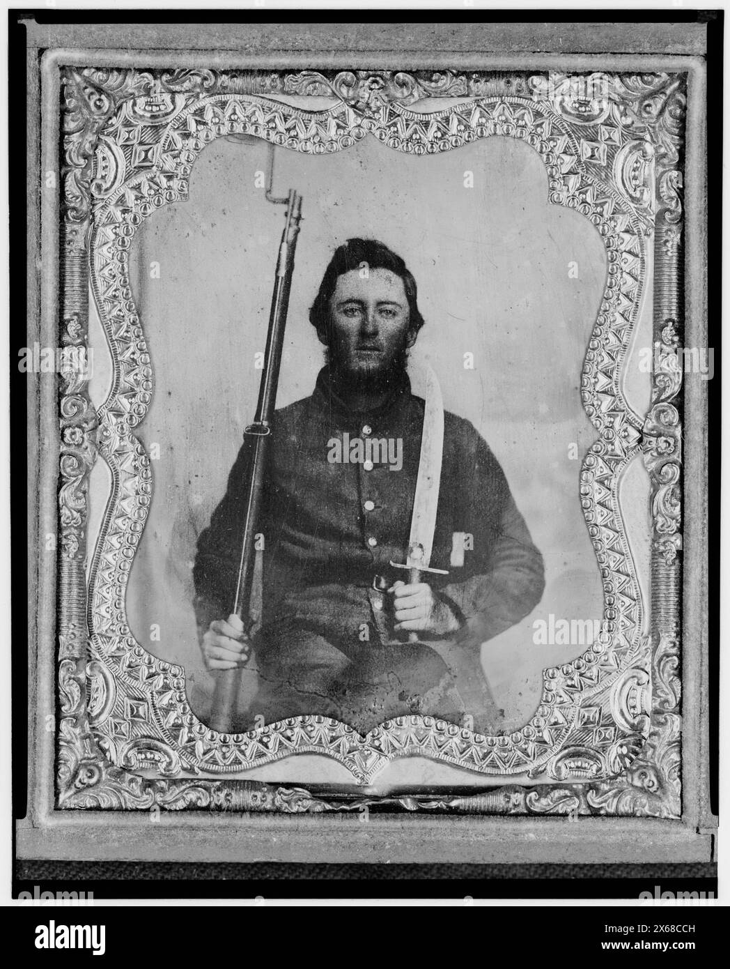 Thomas Kitchen, Pvt., Georgia regiment, C.S.A., three-quarter length portrait, seated holding bayonet and rifle, facing front, Civil War Photographs 1861-1865 Stock Photo