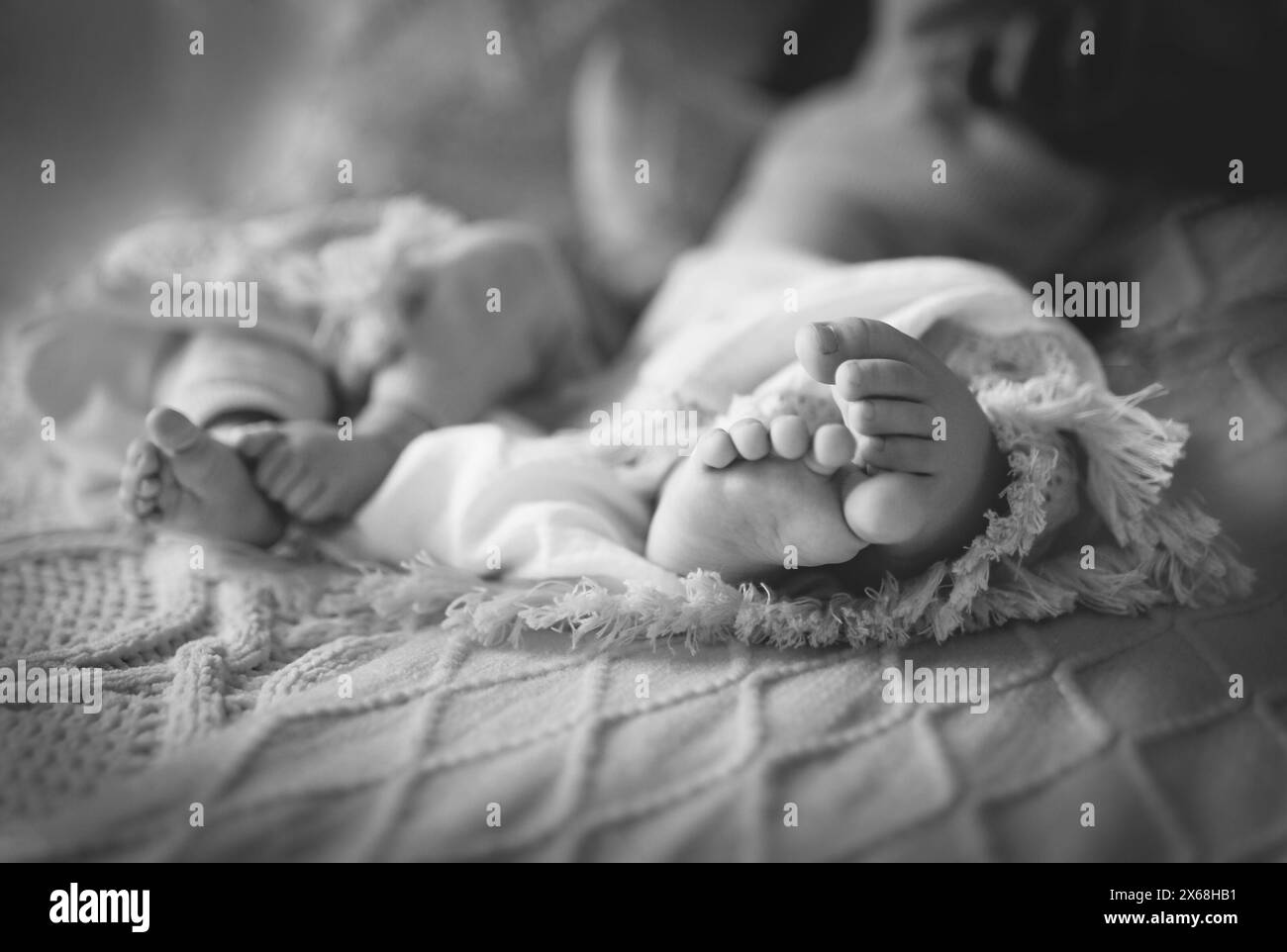 Baby feet in double pack, black and white Stock Photo