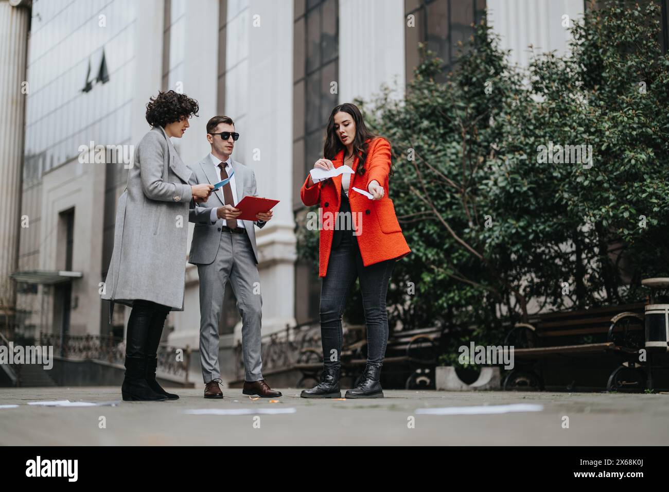 Business partners collaborating on project outdoors with papers Stock Photo