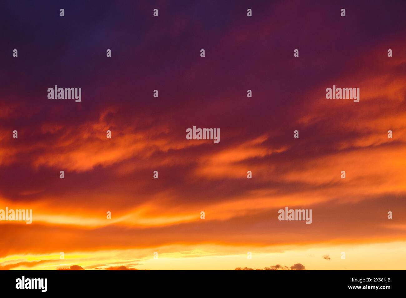 red clouds on the sky at dusk. dramatic nature background. weather change before the rain Stock Photo