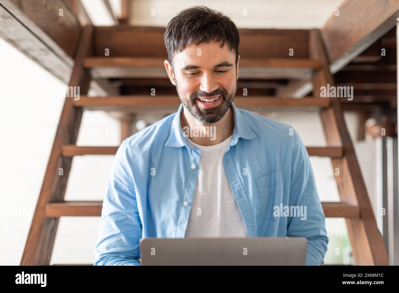 Young man sitting on stairs hi-res stock photography and images - Alamy