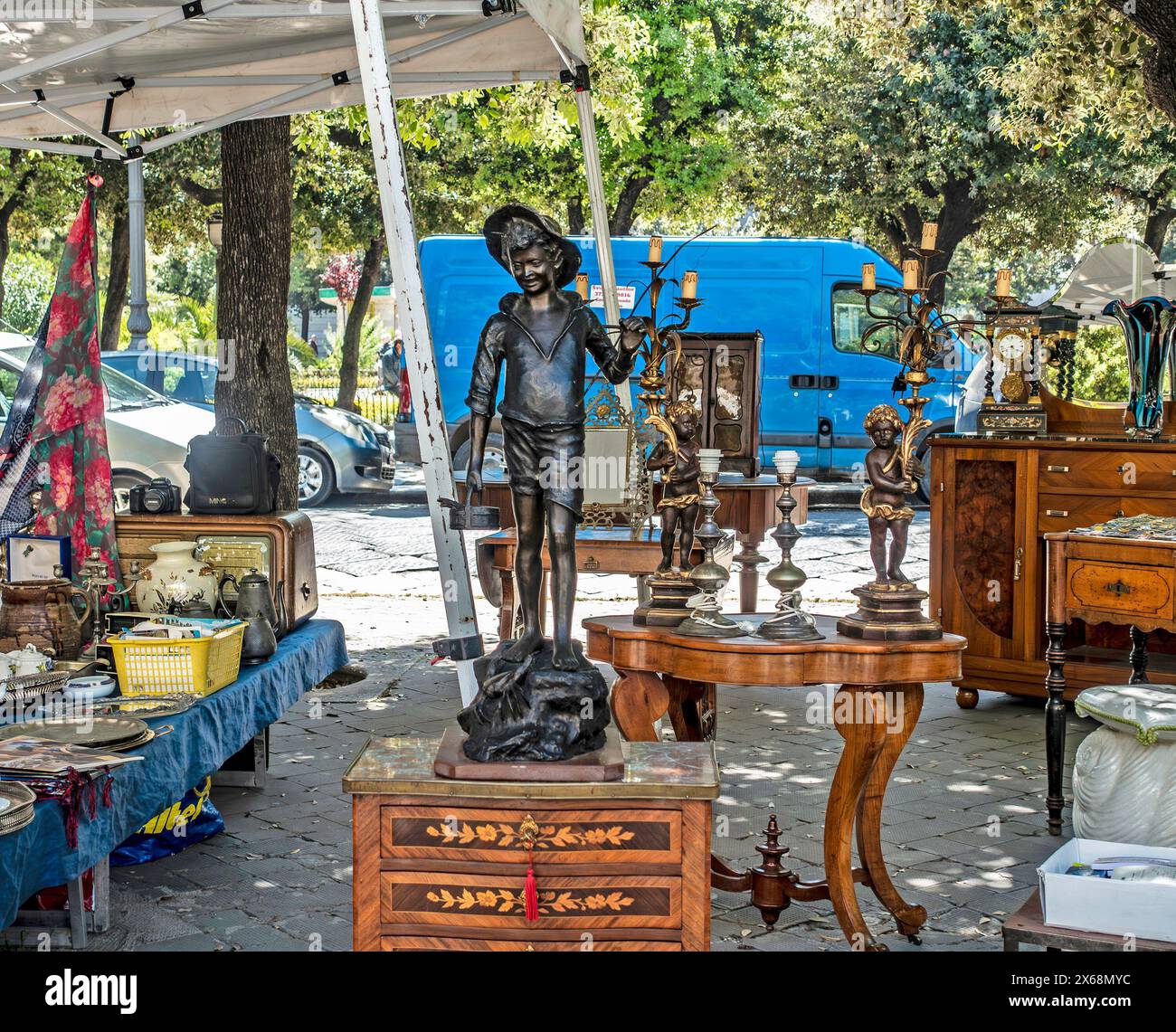 Bronze Statue Centrepiece at an Outdoor Antique Market in Trani, Italy. Stock Photo