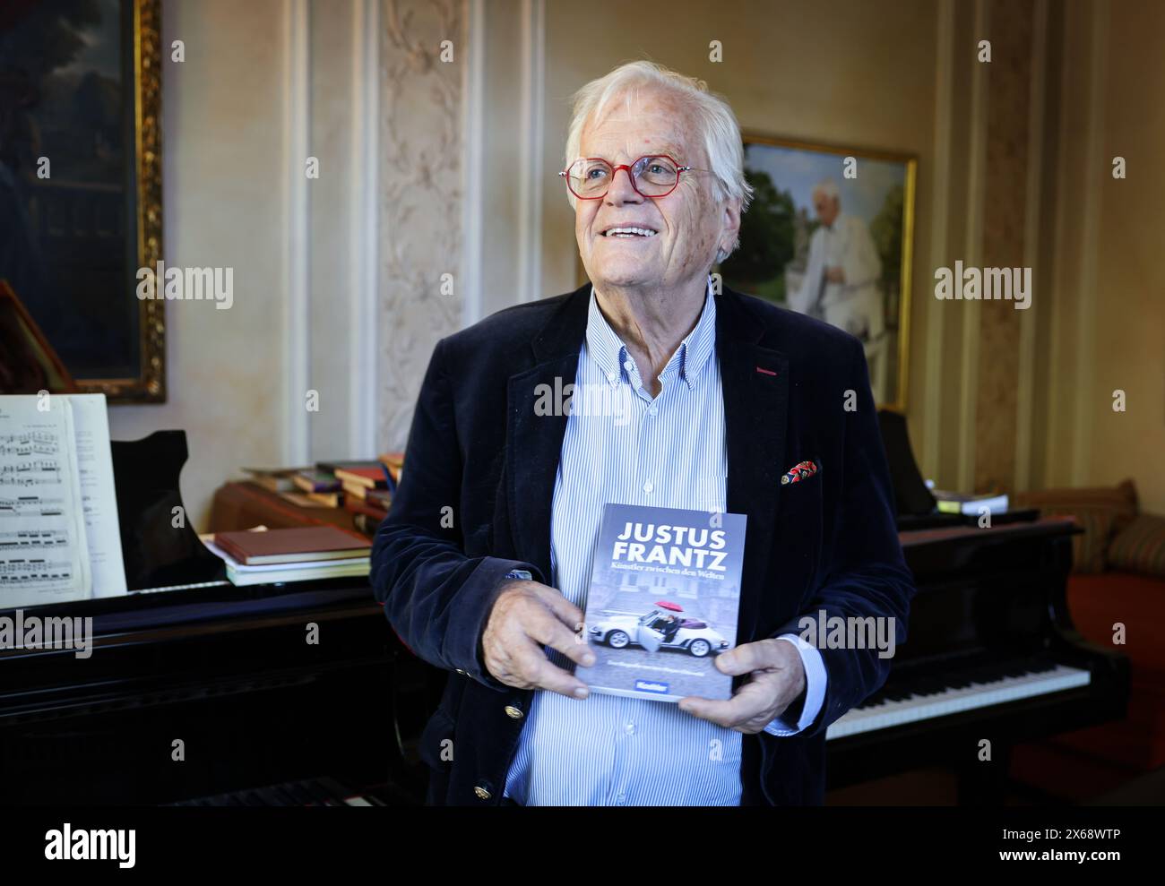 Hamburg, Germany. 13th May, 2024. Justus Frantz, conductor, stands in his music room at the book launch of his biography. The biography ''Justus Frantz - Künstler zwischen den Welten'', written by Jens Meyer-Odewald, will be published by Maximilian Verlag on May 18 to mark Frantz's 80th birthday. Credit: Christian Charisius/dpa/Alamy Live News Stock Photo