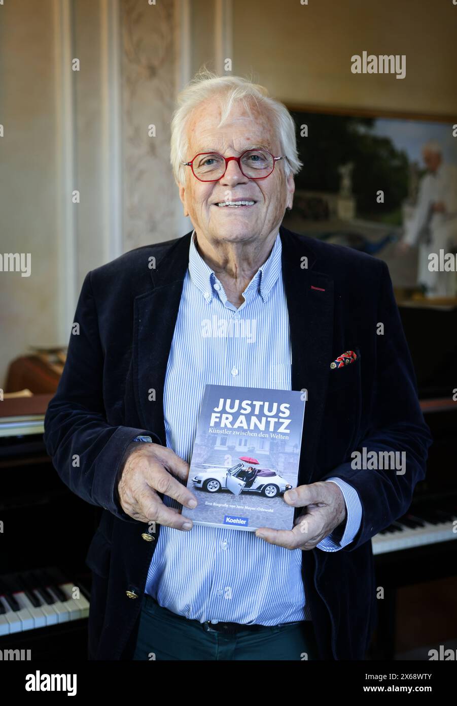 Hamburg, Germany. 13th May, 2024. Justus Frantz, conductor, stands in his music room at the book launch of his biography. The biography ''Justus Frantz - Künstler zwischen den Welten'', written by Jens Meyer-Odewald, will be published by Maximilian Verlag on May 18 to mark Frantz's 80th birthday. Credit: Christian Charisius/dpa/Alamy Live News Stock Photo