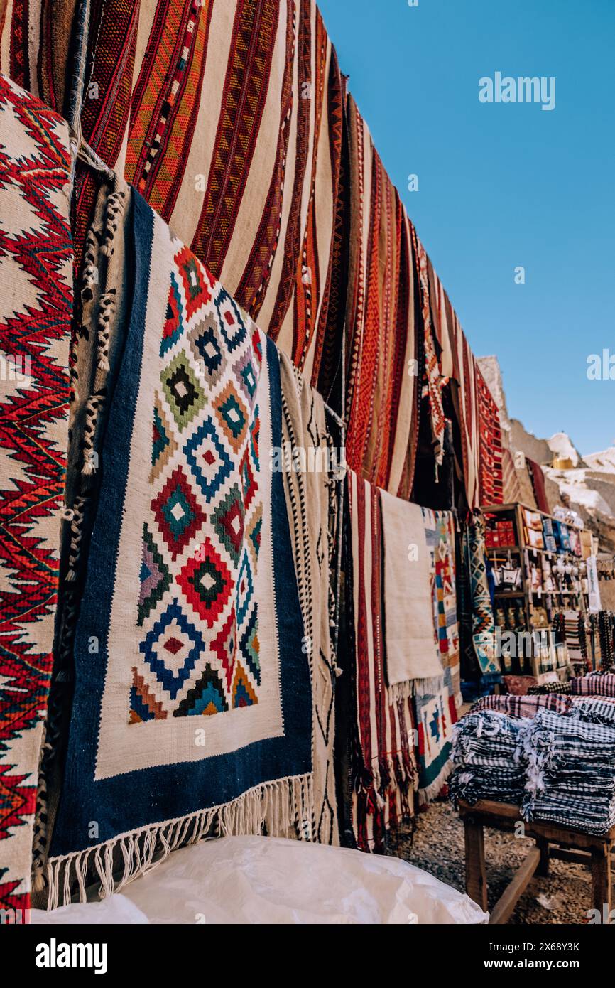 Colorful display of traditional woven rugs at a market in Siwa Oasis, Egypt Stock Photo