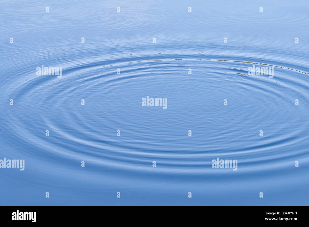 a falling drop of water forms a circle on the surface of a lake, Germany Stock Photo