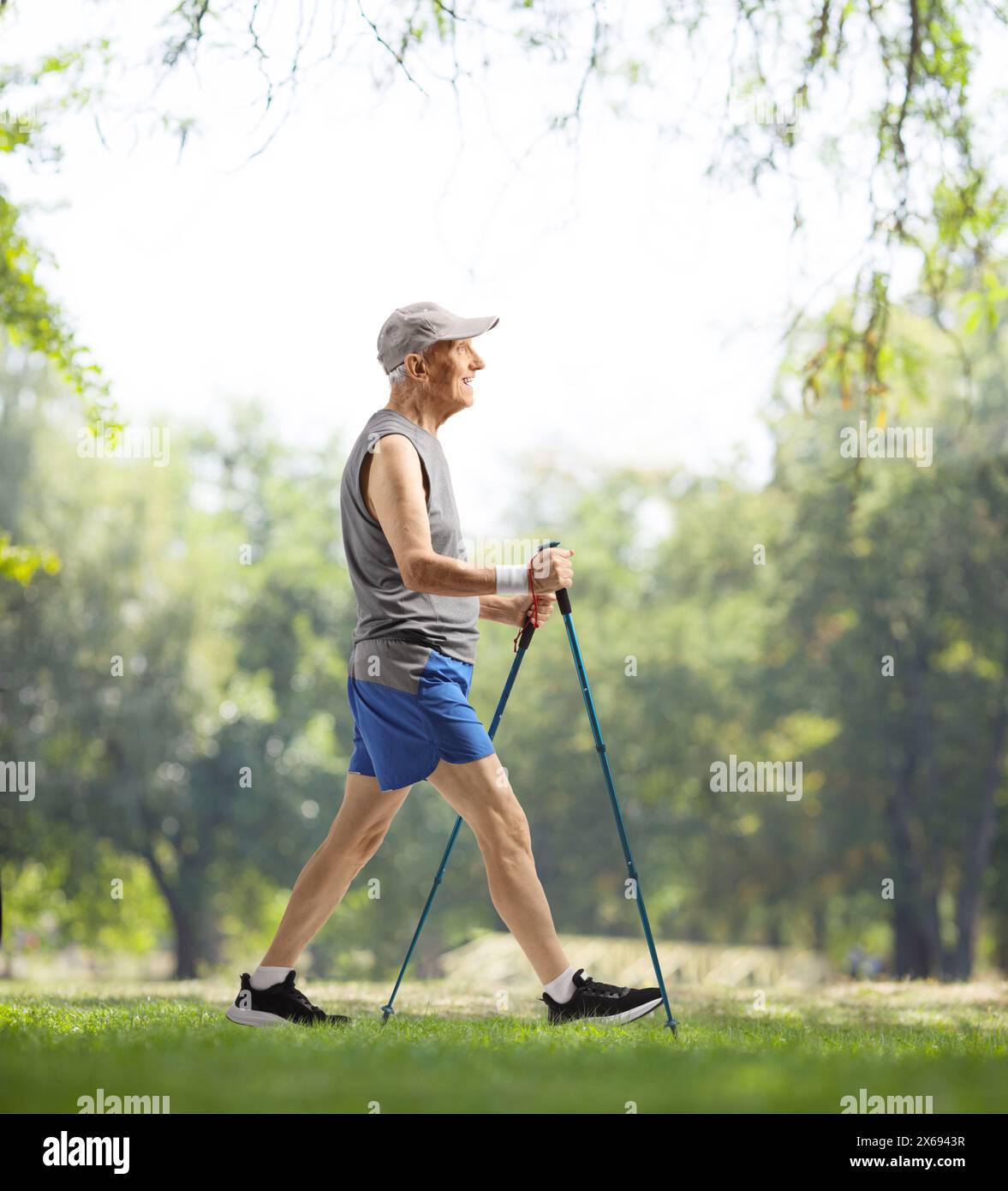 Elderly man walking with poles outdoors in a park Stock Photo