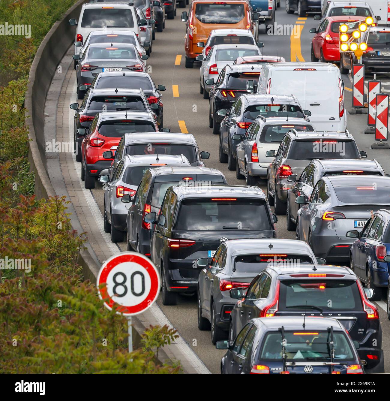 Duisburg, North Rhine-Westphalia, Germany - Traffic jam on the A40 freeway at the Kaiserberg junction. The busy area with the A40 and A3 freeways is being renovated and expanded for years. There are always closures or restrictions for motorists. Stock Photo