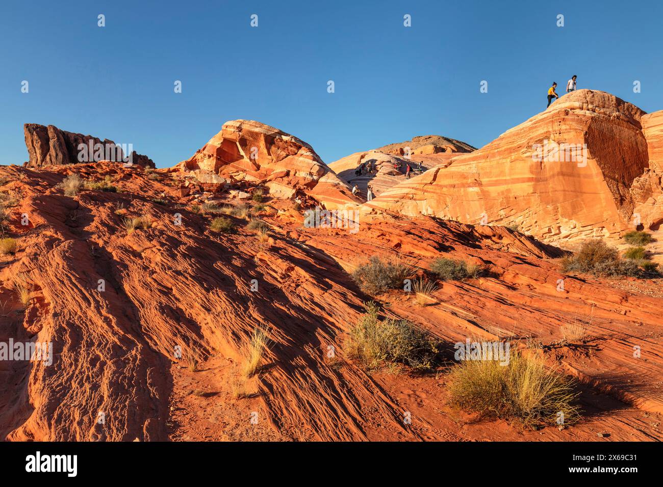 Tourists at Fire Wave Rock, Valley of Fire State Park, Nevada, United ...