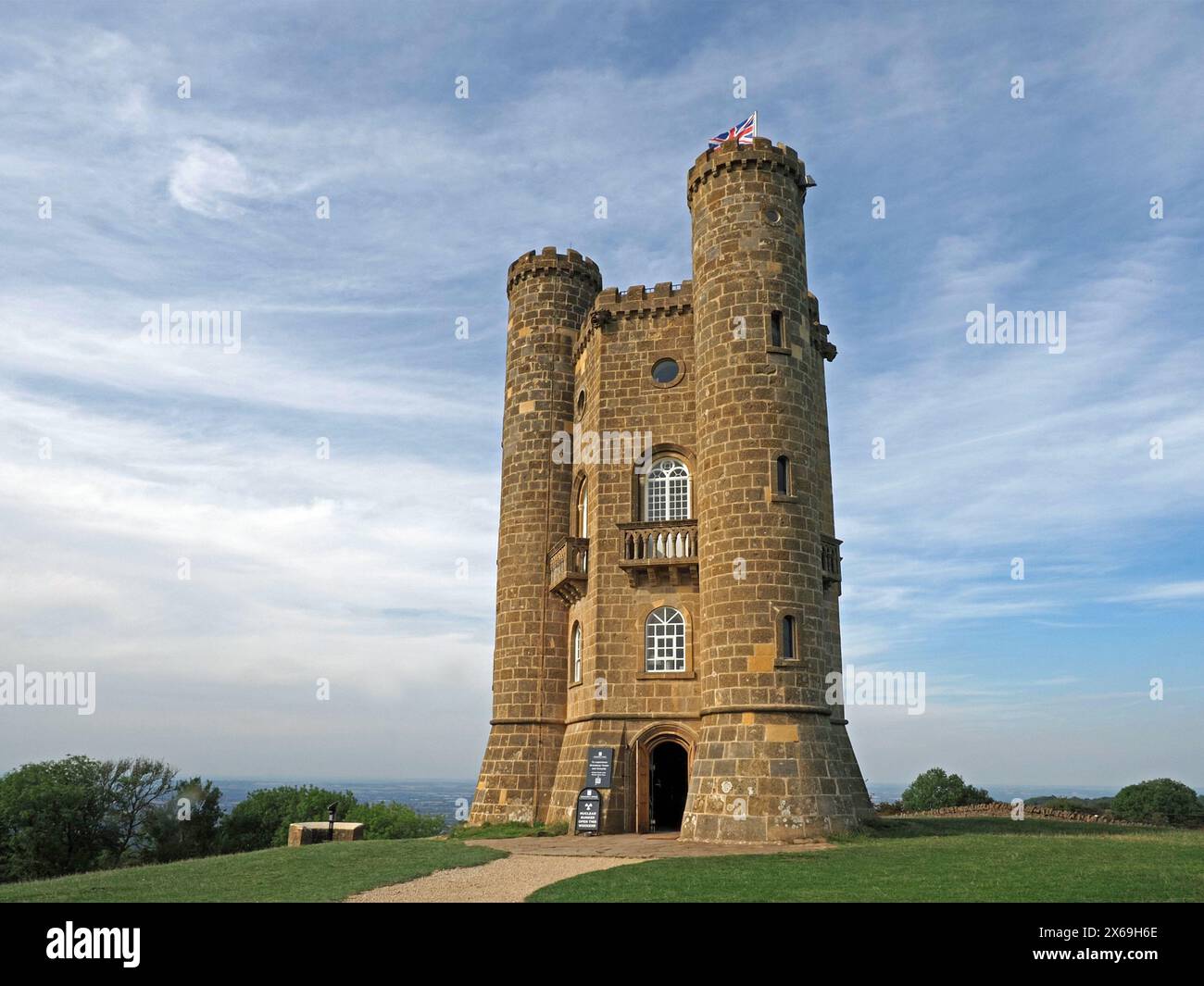 union flag fluttering over stone turret of Broadway Tower a landmark in the Cotswolds England,UK Stock Photo
