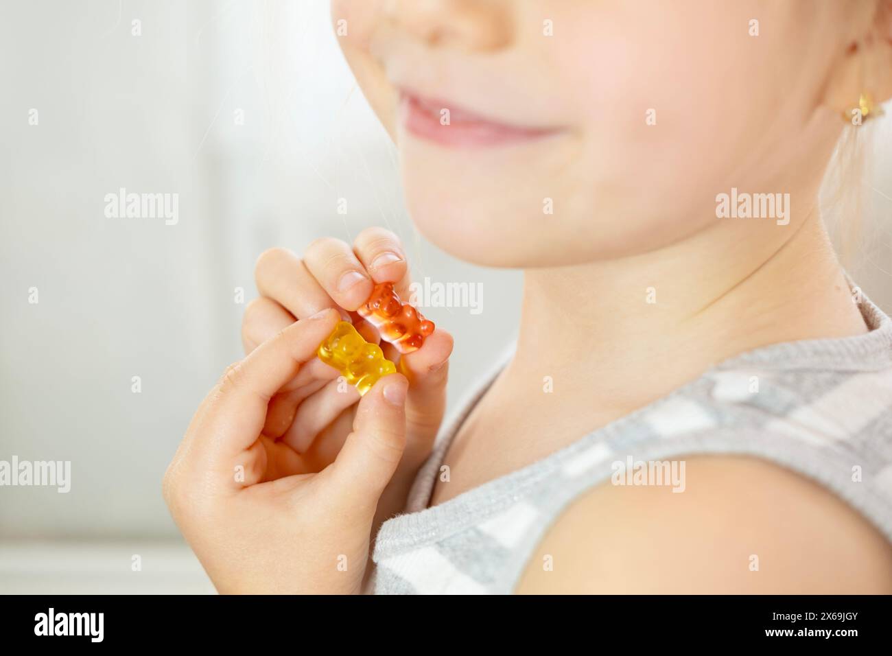 close-up preschool child, girl 5 years old wants eat gelatinous sweets, gummy bear, kid has good appetite, happy childhood, balanced diet, sweet life, Stock Photo