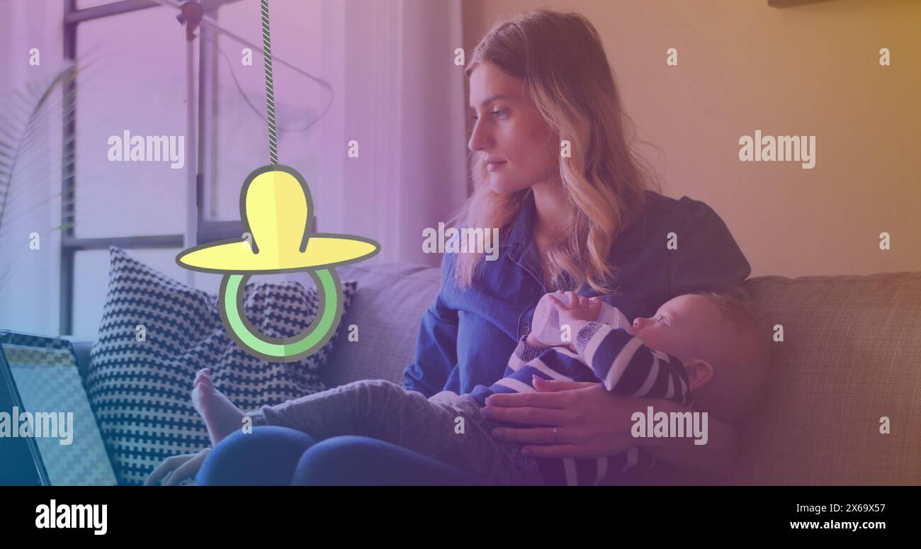 Image of dummy hanging over caucasian woman with baby Stock Photo