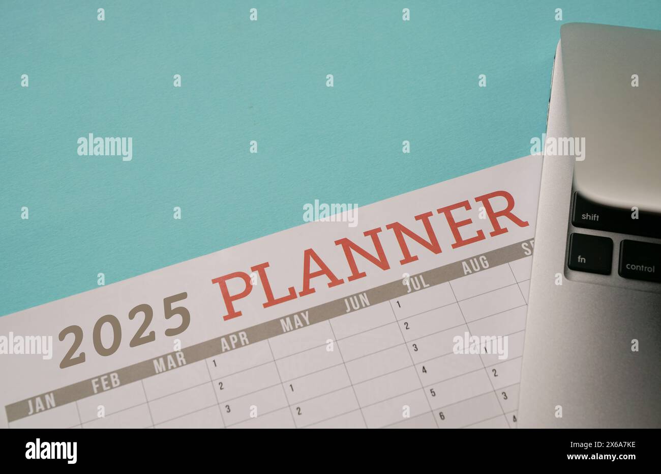 2025 Planner next to a computer laptop Stock Photo Alamy