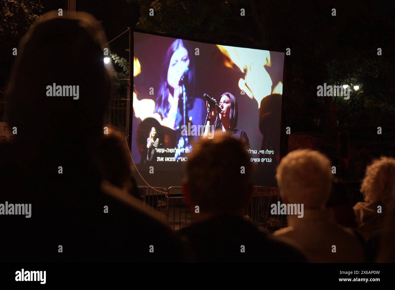 JERUSALEM - MAY 13: People gather to watch a screening of an alternate Independence Day ceremony while calling for a hostage and ceasefire deal on Yom Ha’atzmaut near the private home of PM Netanyahu on May 13, 2024 in Jerusalem. Israel Stock Photo