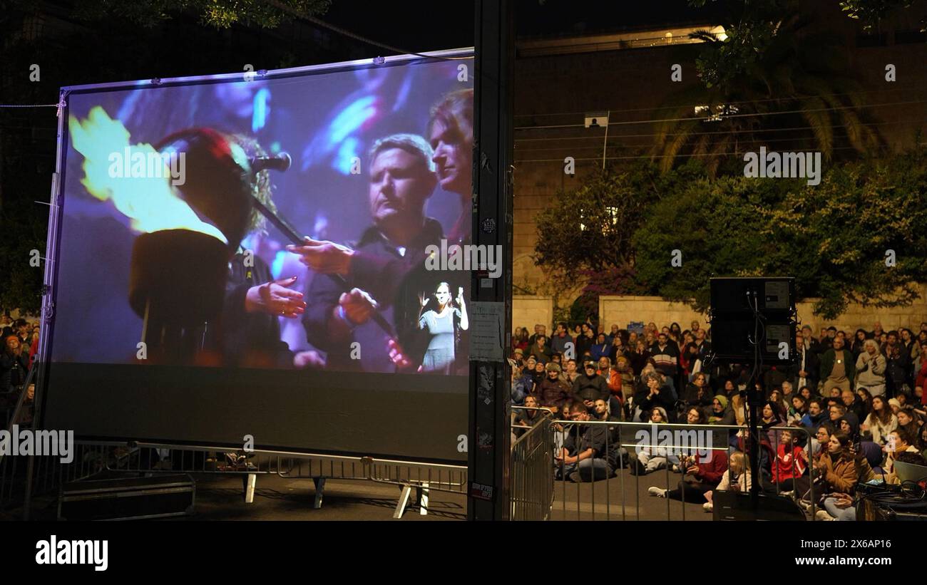 JERUSALEM - MAY 13: People gather to watch a screening of an alternate Independence Day ceremony while calling for a hostage and ceasefire deal on Yom Ha’atzmaut near the private home of PM Netanyahu on May 13, 2024 in Jerusalem. Israel Stock Photo
