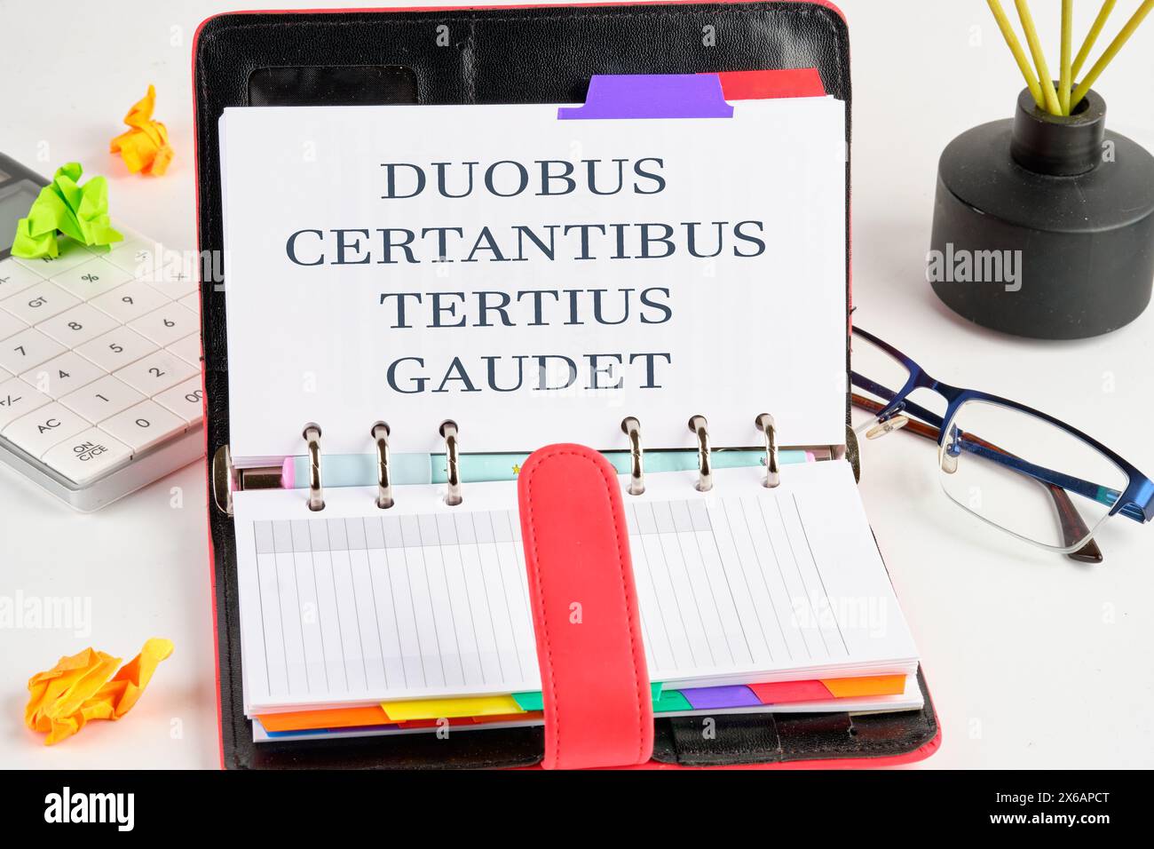 DUOBUS CERTANTIBUS TERTIUS GAUDET it means in Latin While two argue, the third rejoices. on a blank page of the business notebook Stock Photo