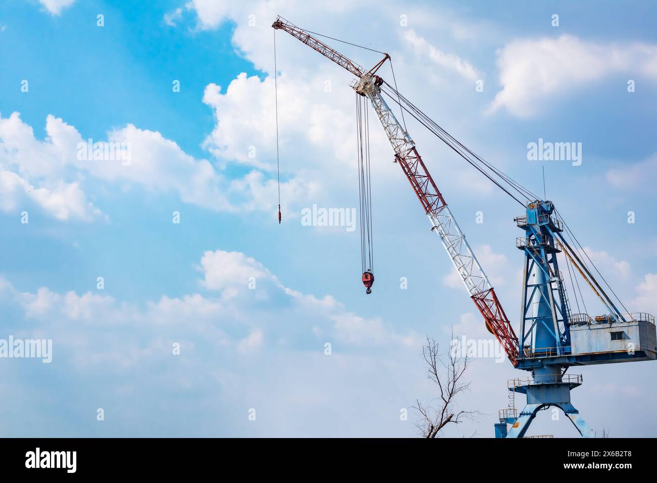 about the tower crane at the construction site and blue sky by emphasizing the tower crane Stock Photo