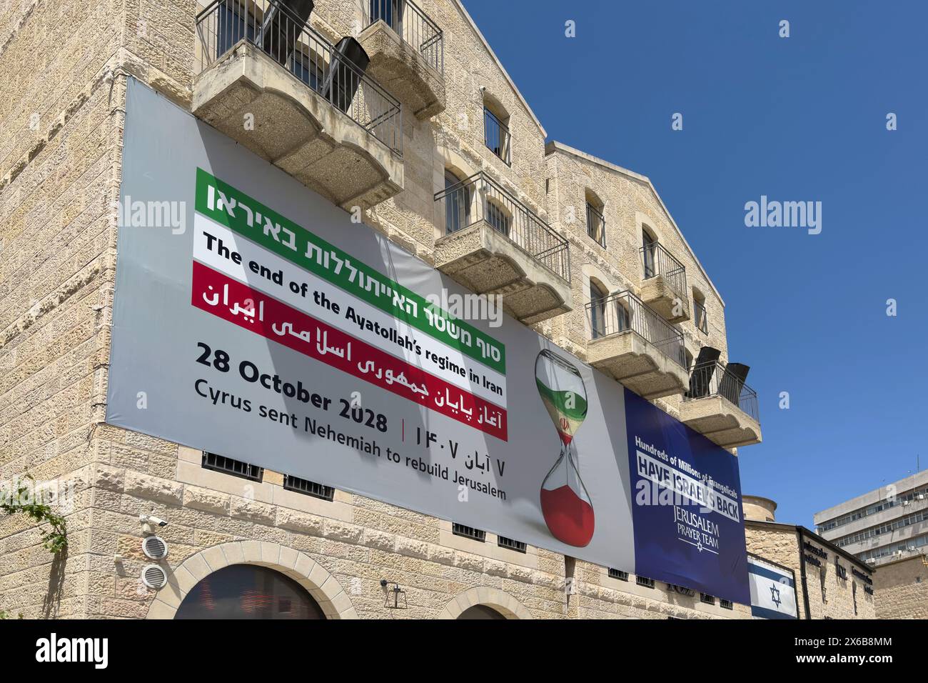JERUSALEM - MAY 6: A billboard funded by an Evangelical group on the building housing The Friends of Zion FOZ Museum which celebrates Christian Zionists and their contribution to Israel, predicts Iran's Ayatollah-led government will fall by October 28, 2028. The statement displays an hourglass depicting the regime's decline on May 6, 2024 in Jerusalem. Kamal Kharrazi, an adviser to Iran's Supreme Leader Ayatollah Ali Khamenei, warned Tehran would rethink its nuclear doctrine if Israel threatens its existence amid West Asian upheaval after the Gaza war. Stock Photo