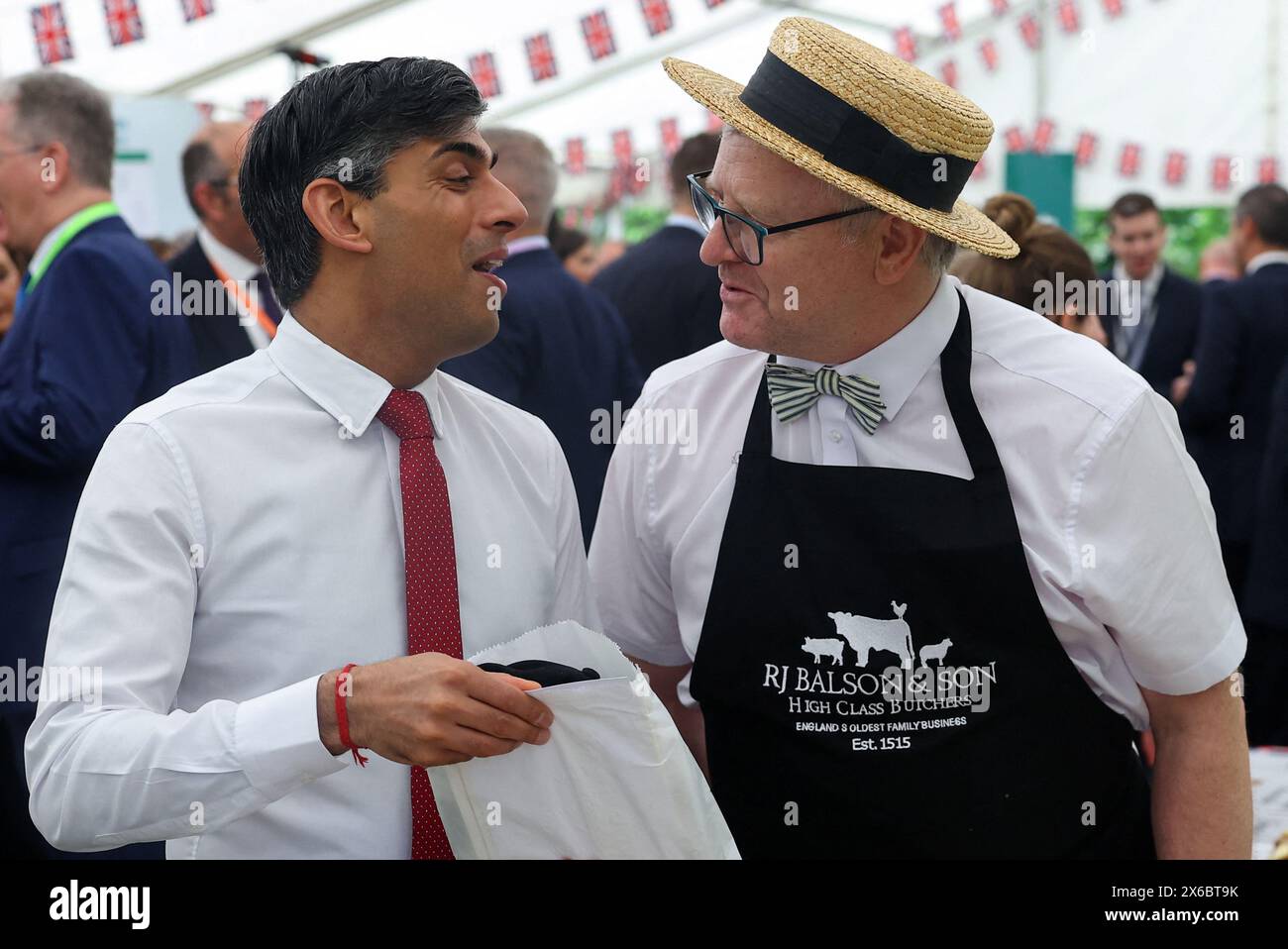 Prime Minister Rishi Sunak speaks with Butcher Richard Balson, as he
