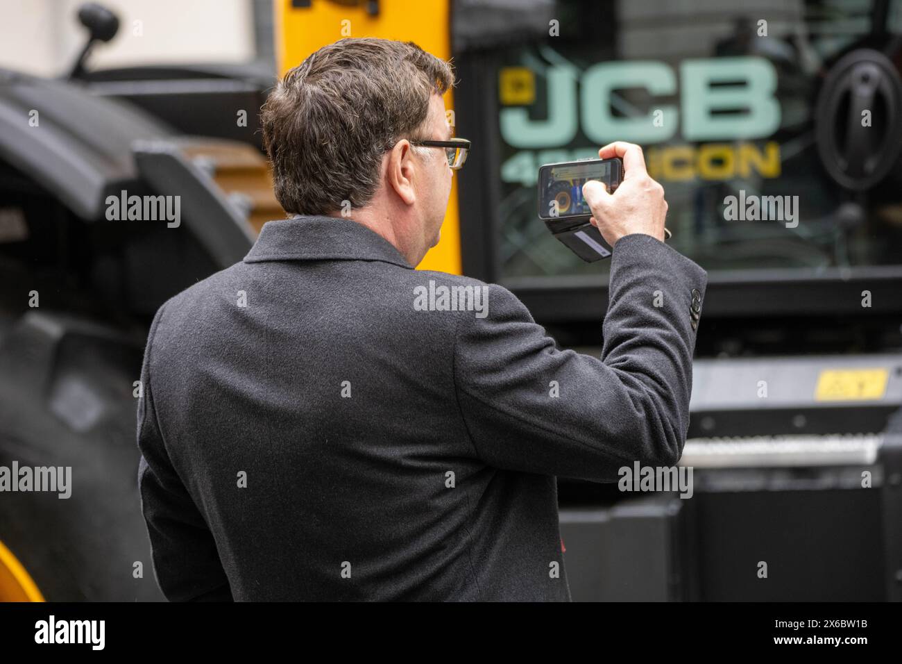 London, UK. 14th May, 2024. Mel Stride, Work and Pensions Secretary, takes a picture of the tractor in Downing Street at as part of thethe farm to folk summit in 10 Downing Street Credit: Ian Davidson/Alamy Live News Stock Photo