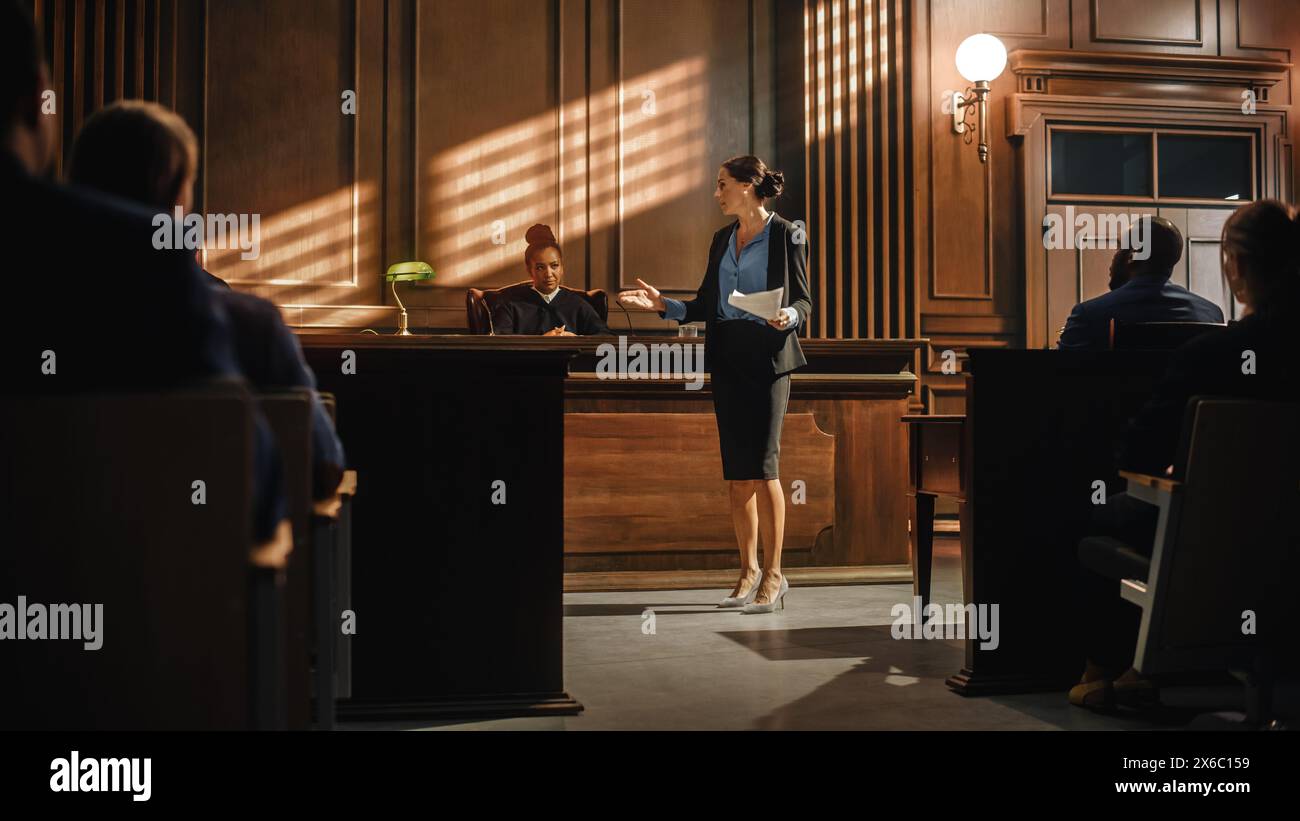 Court of Justice and Law Trial: Successful Female Prosecutor Presenting the Case, Making Passionate Speech to Judge, Jury. Attorney Lawyer Protecting Client with Closing Not Guilty Arguments. Stock Photo