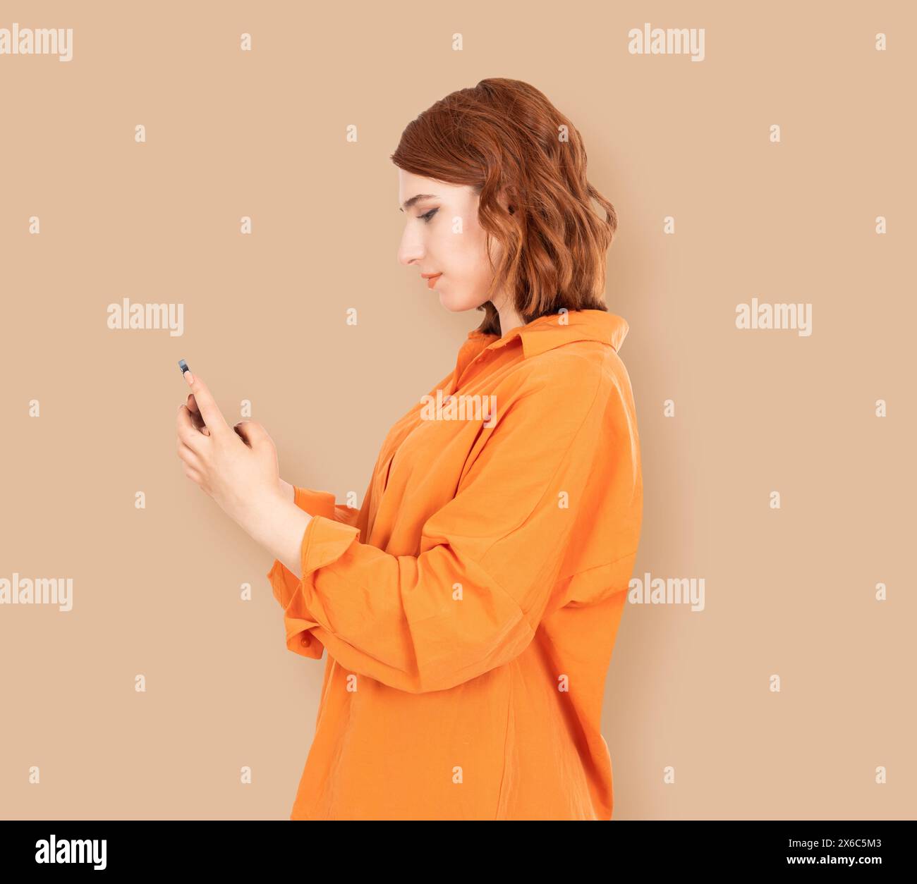 Side view portrait of young beautiful girl woman using mobile phone