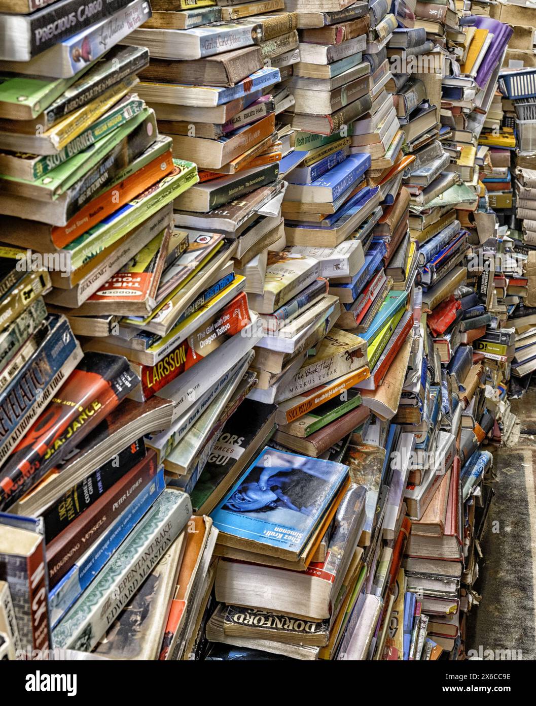 Second hand books for sale stacked floor to ceiling. Stock Photo