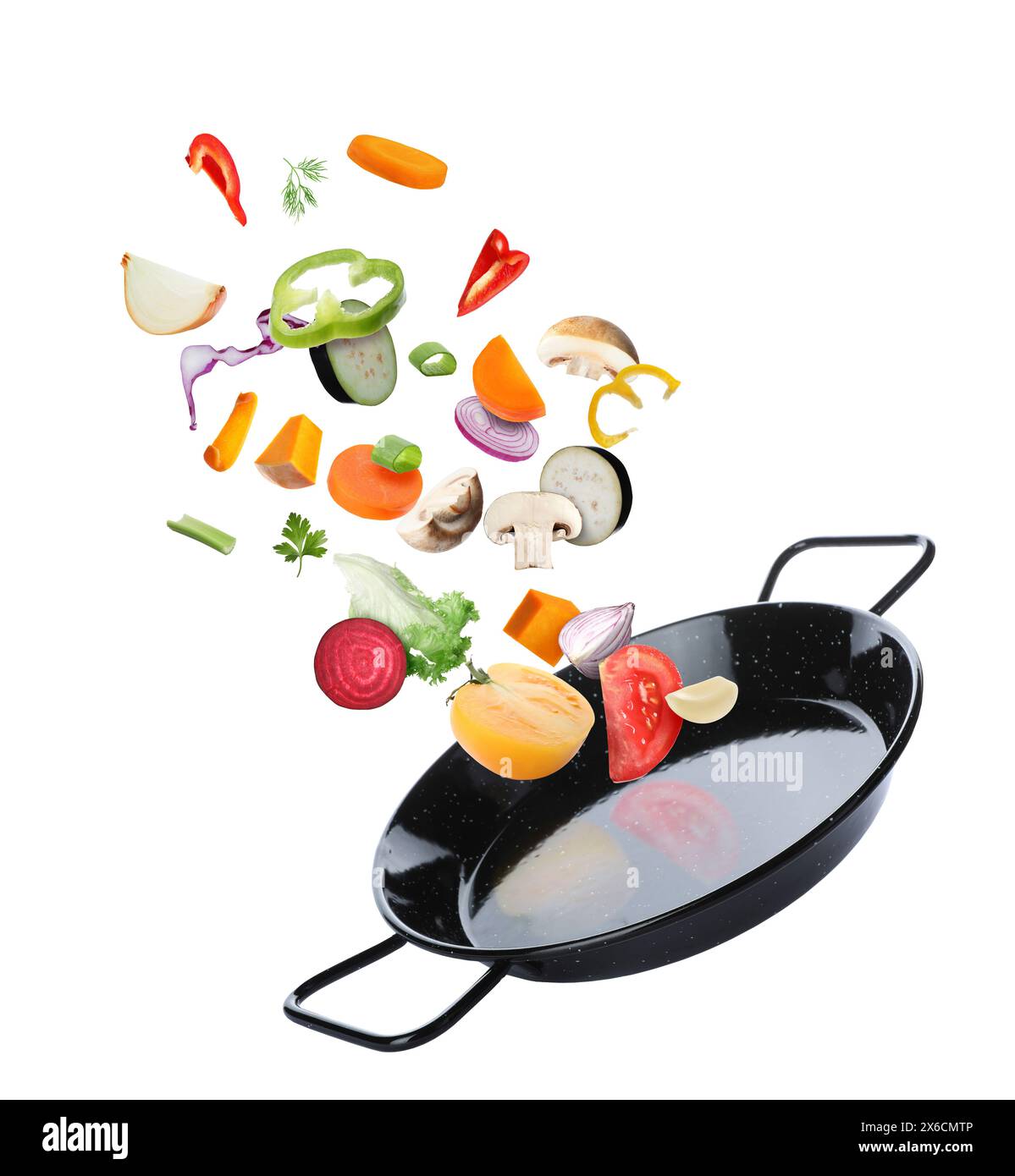 Frying pan and different vegetables in air on white background Stock Photo