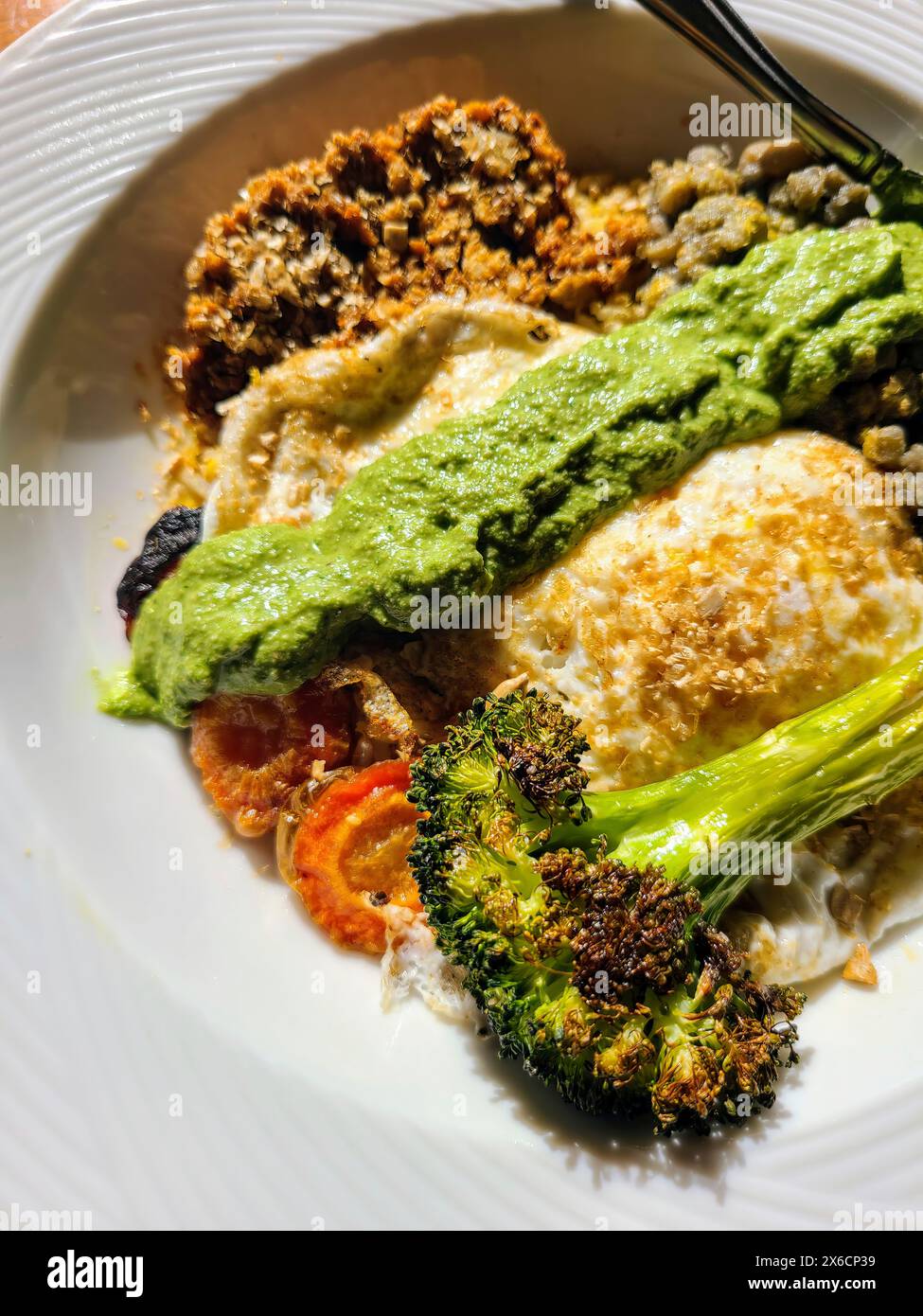 Healthy Vegetarian Plate with Pesto, Sunny Side Egg, Roasted Broccoli - Top View Stock Photo
