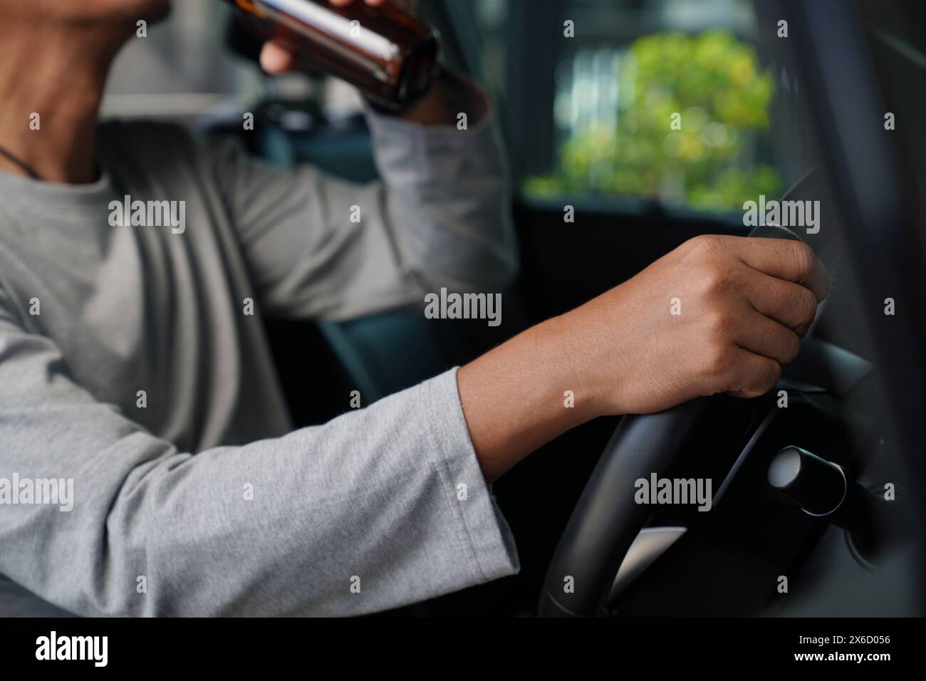 That's a dangerous thing to do. Drinking beer while driving is both