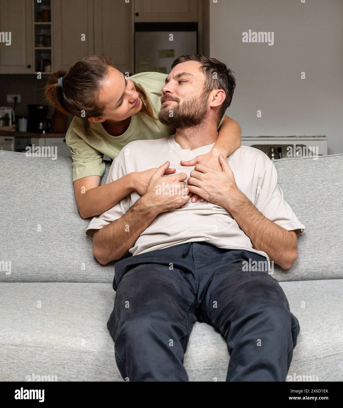 Real young adult couple in love at home while weekend. Relationship and love. Stock Photo
