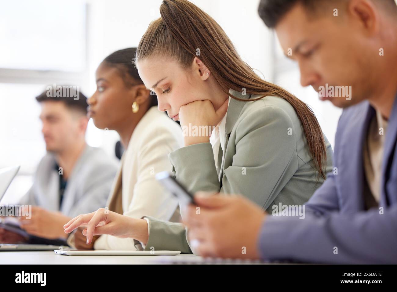 Boring, meeting and team with tablet in office typing notes from workshop or planning schedule. Tired, employee and people in workplace with tech for Stock Photo