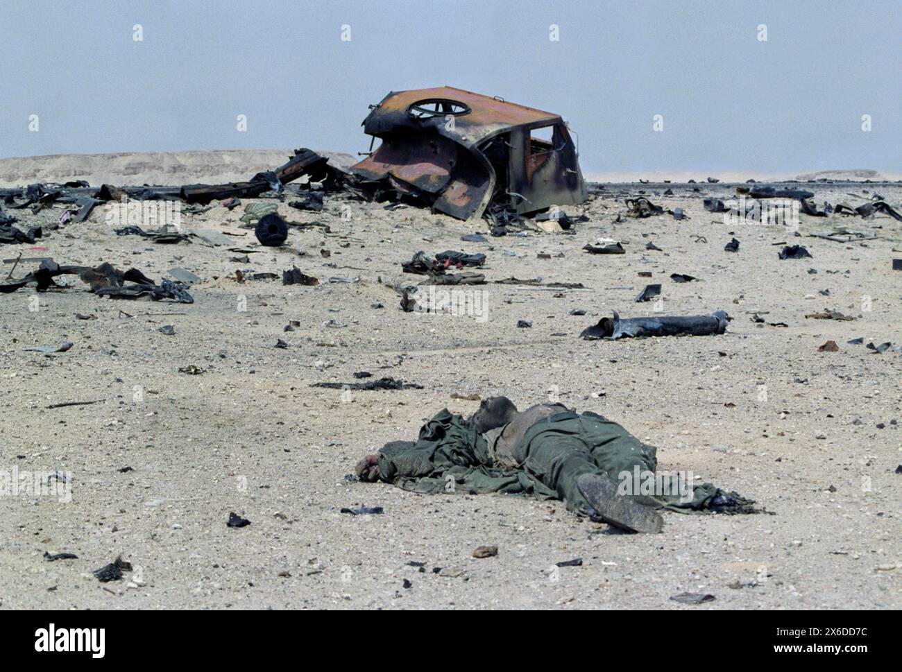 5th March 1991 The dismembered body of an Iraqi soldier lies perhaps 20 metres away from the remains of his Tectran 6x6 AV-LMU truck, which was destroyed by USAF fighter jets. Stock Photo