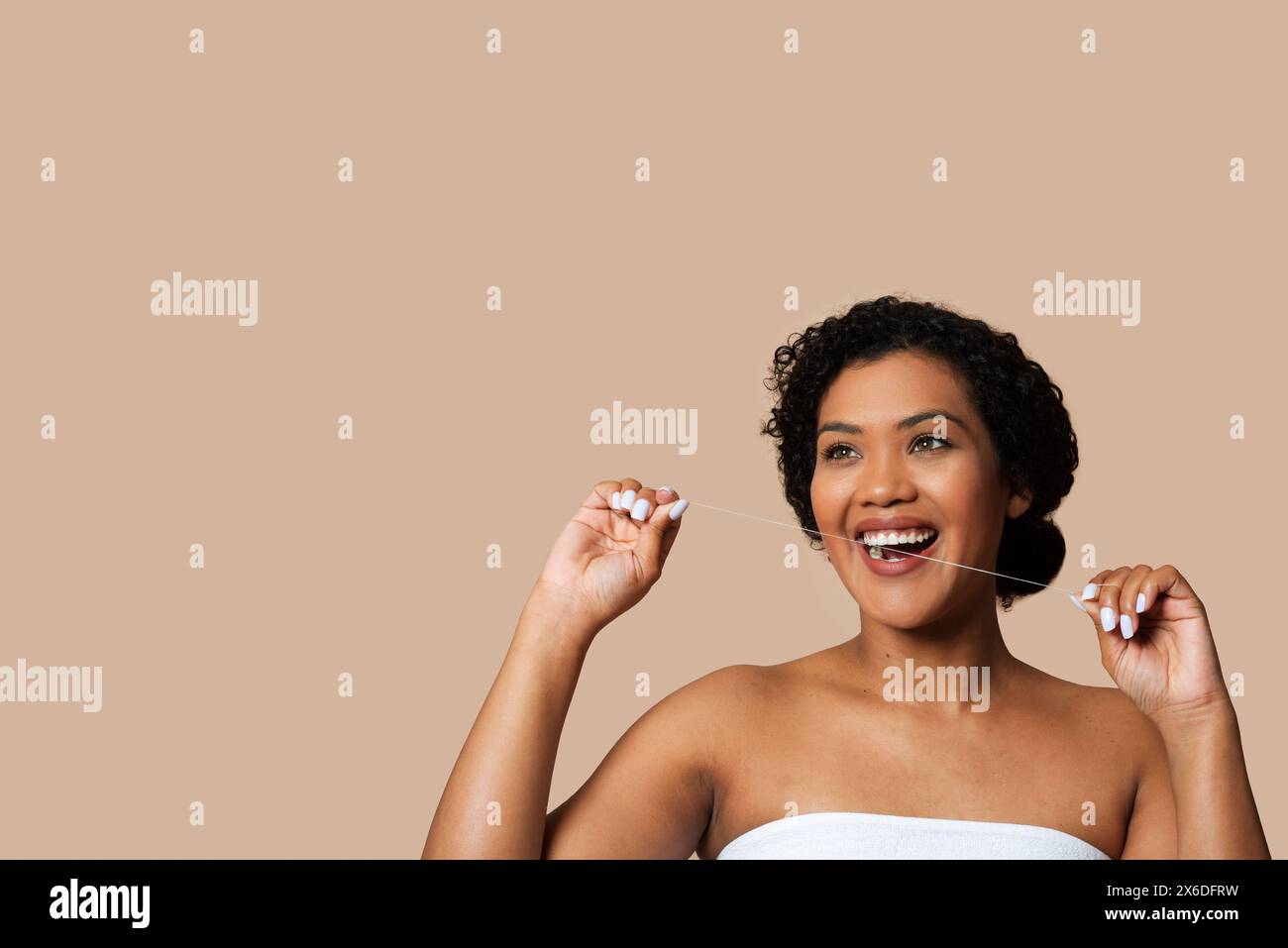 Joyful Woman With Short Curly Hair Flossing Teeth Stock Photo