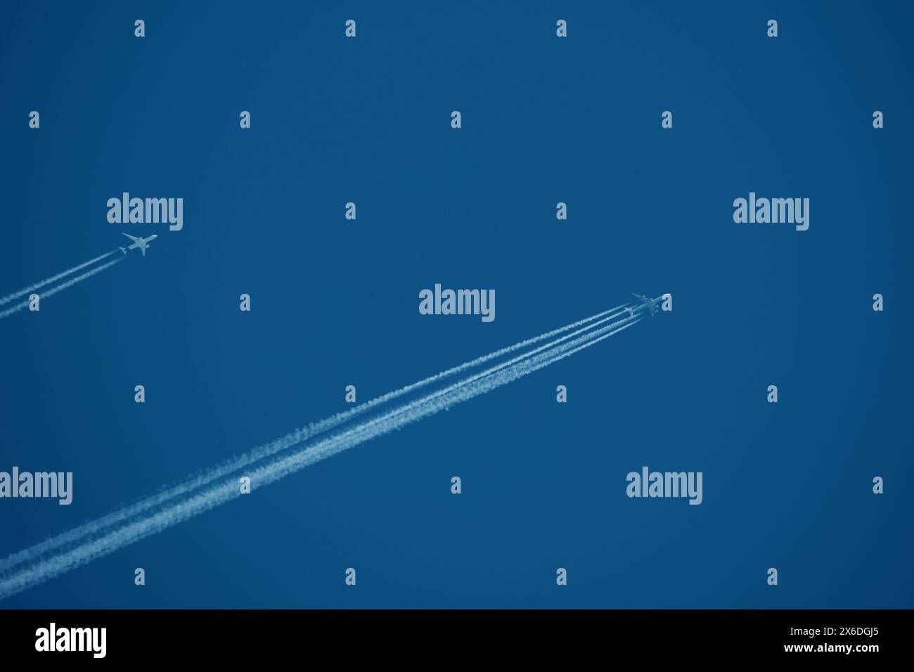 two parallel airplane tracks in the blue sky, contrails Stock Photo - Alamy